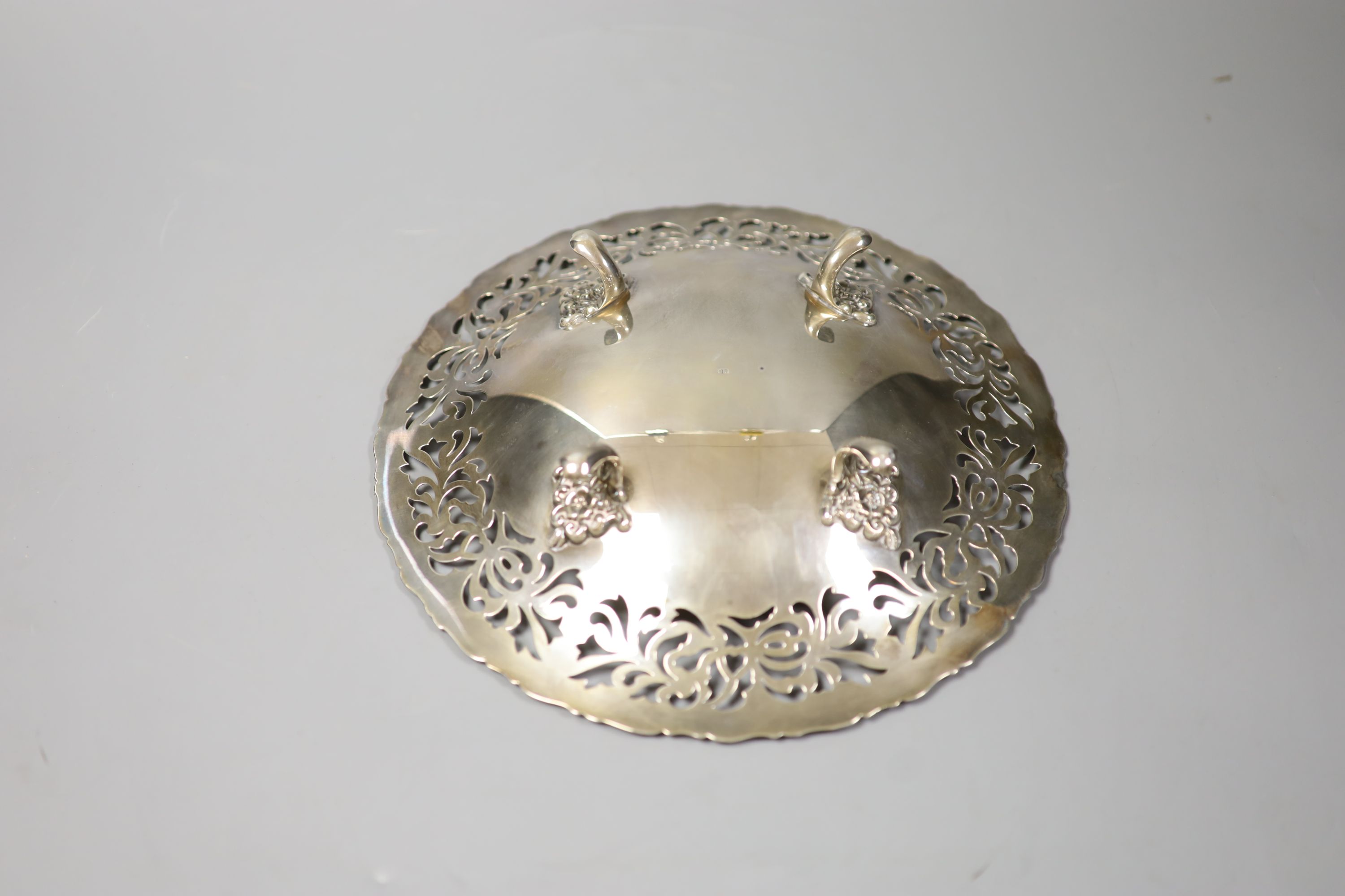 A Chinese circular white metal cake dish with pierced border